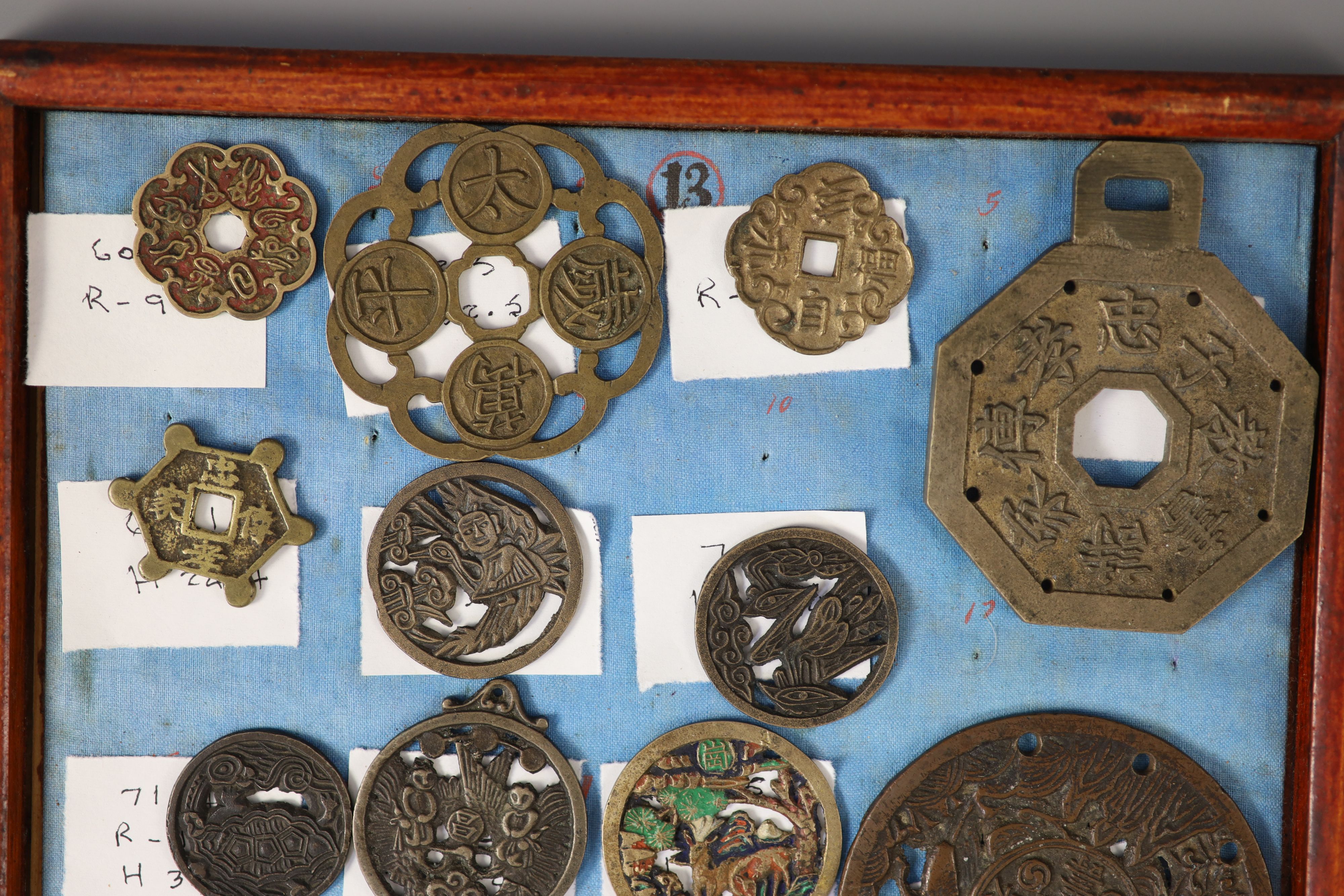 A group of 99 Korean bronze and metal amulets or charms, 19th/20th century